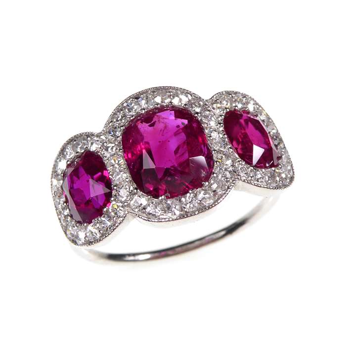 Early 20th century ruby and diamond three stone cluster ring, c.1915, the cushion shaped Burma rubies 1.52ct, 0.77ct & 0.77ct,